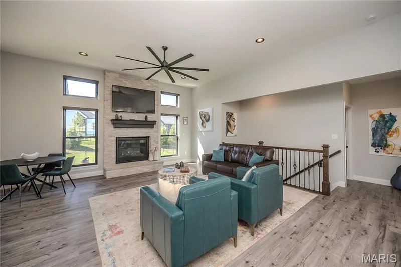 The lounge area is crowned with a contemporary fan with a sculptural twist.  Casual dining can also foster game night by the fire and your favorite show. — 121 Eagle Estates Drive, Lake St. Louis, MO 63367