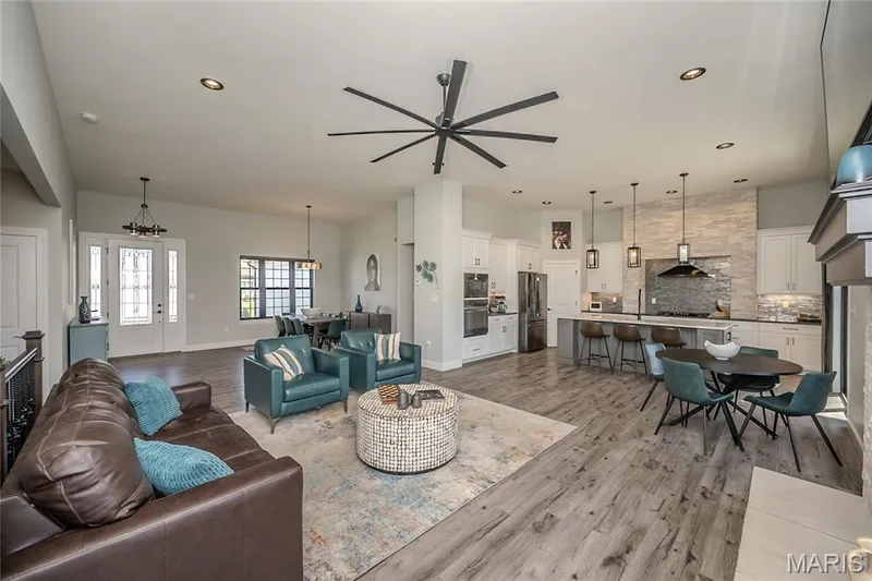 This photo captures the flow among the zones. The Kitchen beyond is a work of art. — 121 Eagle Estates Drive, Lake St. Louis, MO 63367