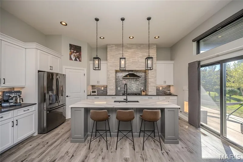 To the left of the window is the wagic window/door for you 4 legged guest.  Fashionable collars for 2 and 2 for their guests allow them to enjoy the outdoors. — 121 Eagle Estates Drive, Lake St. Louis, MO 63367