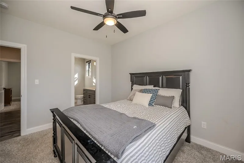 The open door is to the private ensuite bath of the guest suite. — 121 Eagle Estates Drive, Lake St. Louis, MO 63367