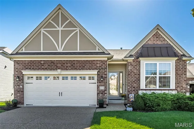 Brick facade with decorative gables and a covered front entry — 1509 Woodside Hills Drive, St Peters, MO 63376