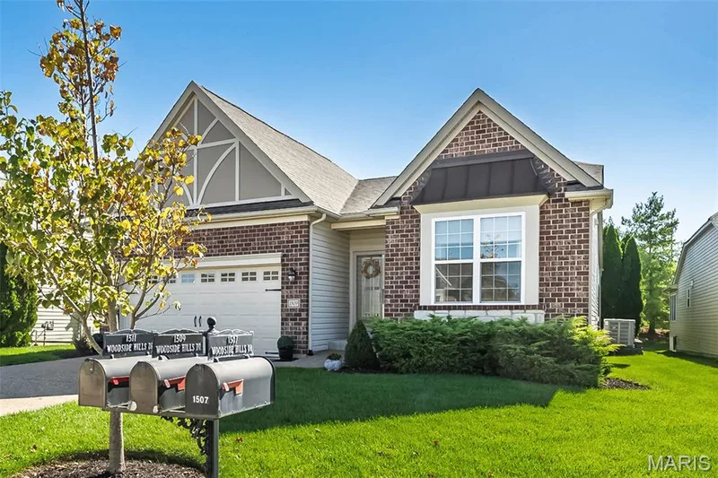 Brick exterior with siding accents and an attached garage — 1509 Woodside Hills Drive, St Peters, MO 63376