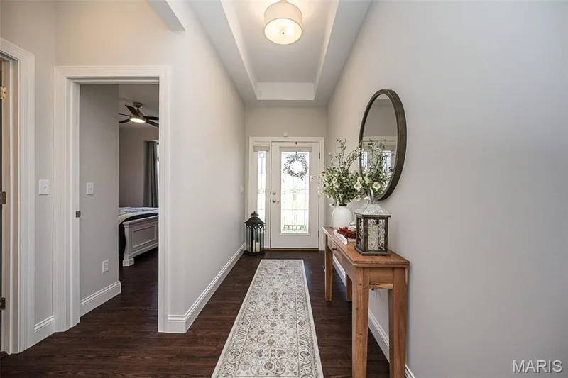 Hardwood-finish flooring, recessed ceiling with a flush-mount light fixture, and a front entry door with sidelights — 1509 Woodside Hills Drive, St Peters, MO 63376