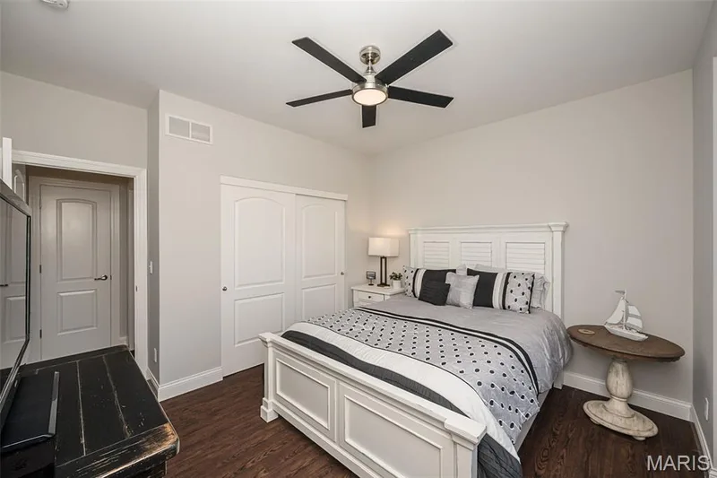 Wood-finish flooring with a ceiling fan featuring a light fixture — 1509 Woodside Hills Drive, St Peters, MO 63376