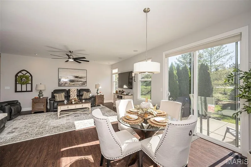 Spacious interior featuring wood-finish flooring and a contemporary ceiling fan — 1509 Woodside Hills Drive, St Peters, MO 63376