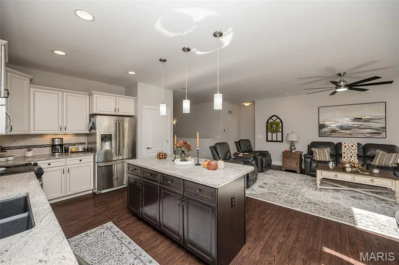Open concept living space featuring wood-finish flooring, recessed lighting, and a ceiling fan — 1509 Woodside Hills Drive, St Peters, MO 63376