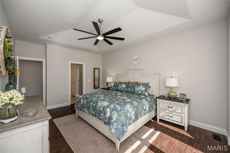 Tray ceiling with recessed lighting, dark wood-finish flooring, and light-toned walls — 1509 Woodside Hills Drive, St Peters, MO 63376