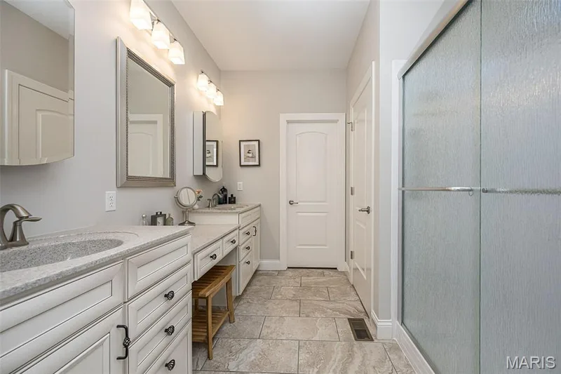 Dual vanity with light-toned countertops and integrated sinks — 1509 Woodside Hills Drive, St Peters, MO 63376