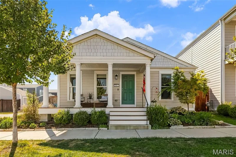 Sit back, relax, and enjoy the neighborhood charm from your own inviting covered front porch! — 6002 Suntan Drive, St Charles, MO 63301