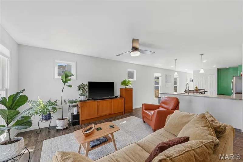 Bright and spacious family room with plenty of windows, natural light, and an open layout perfect for gathering and entertaining! — 6002 Suntan Drive, St Charles, MO 63301
