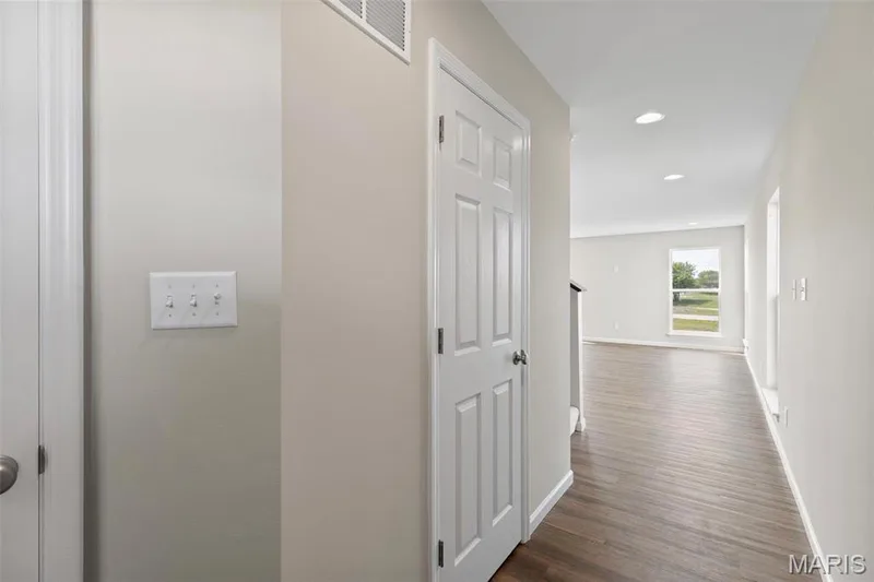 Hallway featuring dark hardwood / wood-style floors — 2 Burlington at Fairmount Grove, St Peters, MO 63376