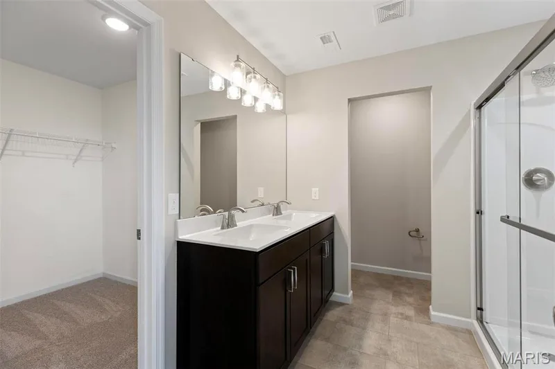 Bathroom with vanity and an enclosed shower — 2 Burlington at Fairmount Grove, St Peters, MO 63376