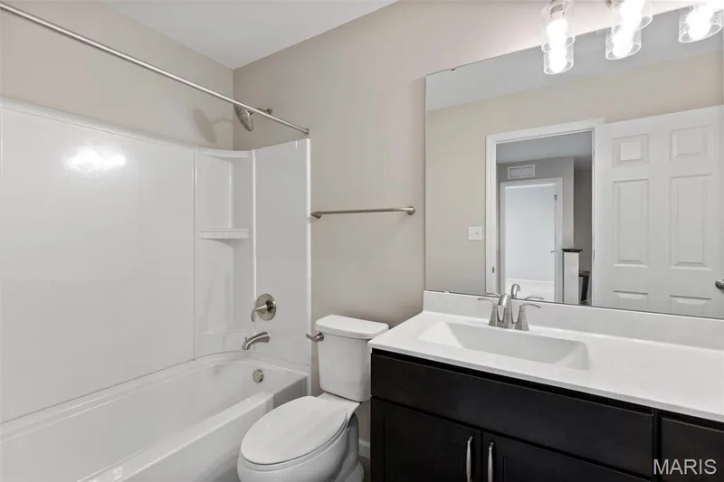 Full bathroom with shower / tub combination, vanity, and toilet — 2 Burlington at Fairmount Grove, St Peters, MO 63376