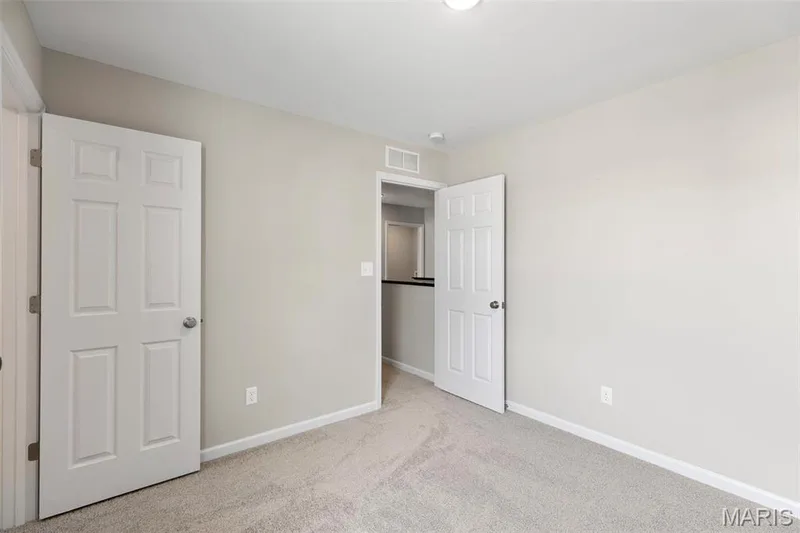 Unfurnished bedroom featuring light carpet — 2 Burlington at Fairmount Grove, St Peters, MO 63376