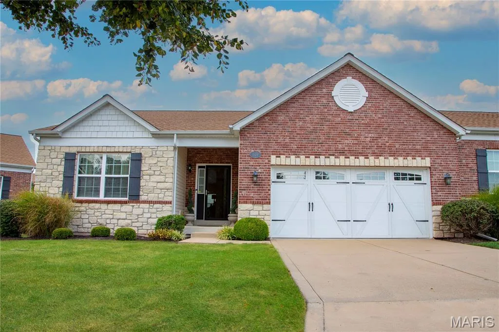 Brick and stone facade with a gable roof, decorative shutters, and an attached two-car garage — 149 Amiot Court, Chesterfield, MO 63146