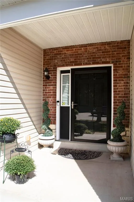 Brick facade with complementary siding, covered entry, and black entry door — 149 Amiot Court, Chesterfield, MO 63146