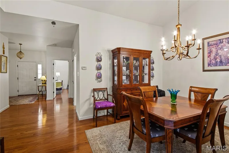 Hardwood flooring throughout, with a recessed entry leading to an open dining area — 149 Amiot Court, Chesterfield, MO 63146