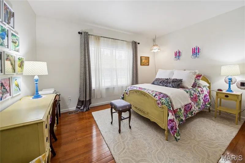 Hardwood flooring paired with a light-colored area rug — 149 Amiot Court, Chesterfield, MO 63146