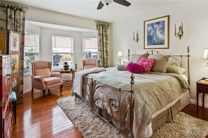 Hardwood flooring, bay window with blinds, ceiling fan, and ornate wall sconces — 149 Amiot Court, Chesterfield, MO 63146