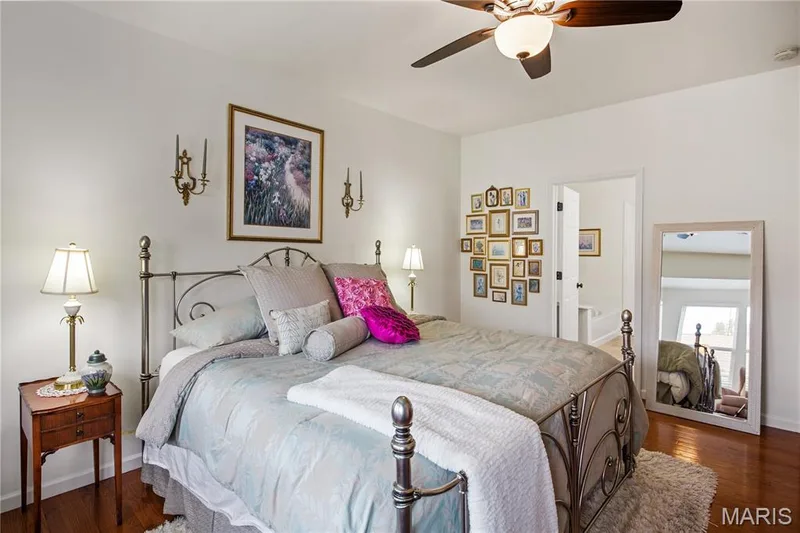 Hardwood flooring, ceiling fan with integrated lighting, recessed wall sconces, and an open doorway — 149 Amiot Court, Chesterfield, MO 63146