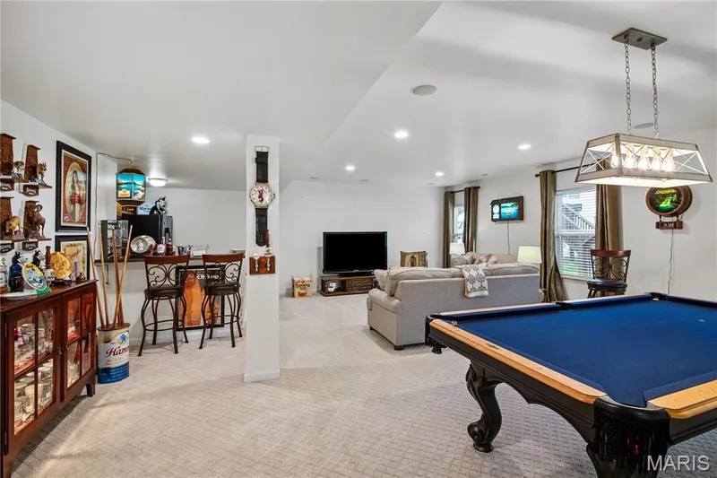 Expansive finished lower level,with deep pour, featuring carpet flooring, recessed lighting, and a built-in wet bar area — 149 Amiot Court, Chesterfield, MO 63146