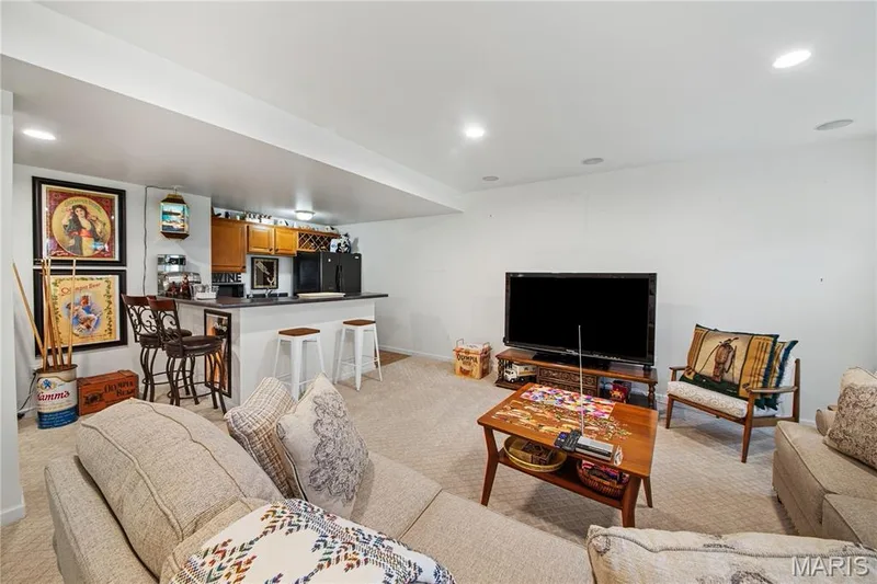 Recessed ceiling lighting, built-in wet bar, wood cabinetry, built-in wine rack, and carpeted flooring — 149 Amiot Court, Chesterfield, MO 63146