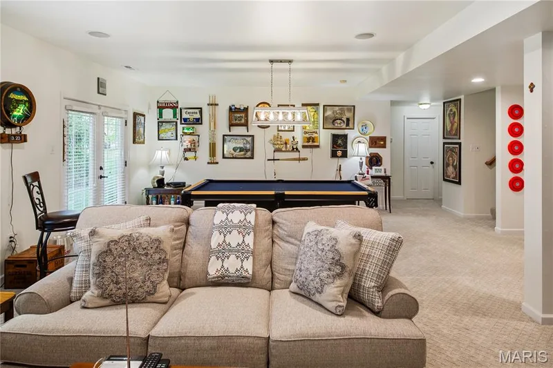 Recessed lighting, light-colored carpeting, French doors with integrated blinds, a billiard table, and a contemporary linear chandelier — 149 Amiot Court, Chesterfield, MO 63146