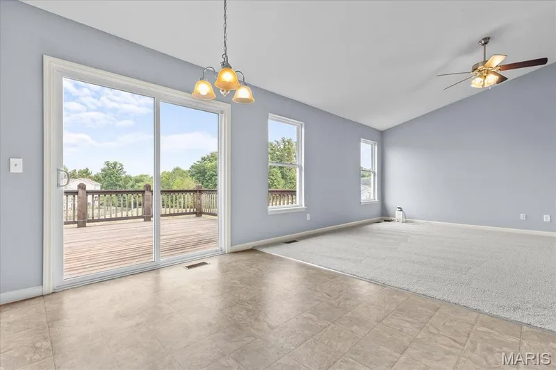 Vaulted ceiling with ceiling fan, sliding glass door, recessed windows, light fixture, and wood-finish deck — 521 Cimarron Woods Court, Wentzville, MO 63385