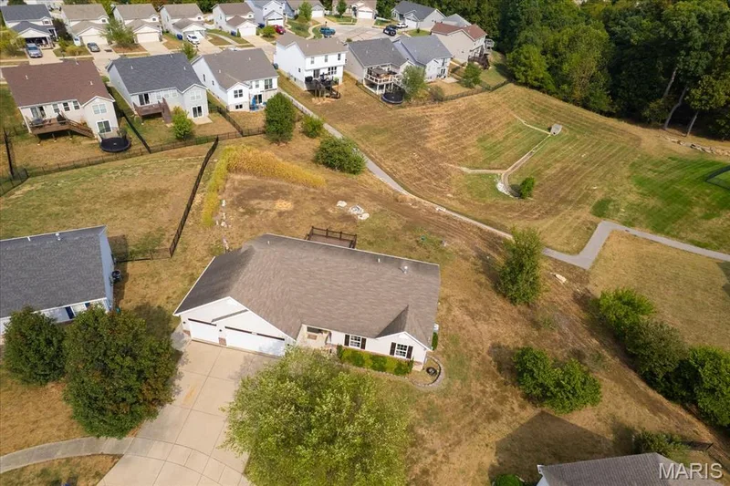 Single-story residence featuring a two-car garage, concrete driveway, and a shingle roof — 521 Cimarron Woods Court, Wentzville, MO 63385