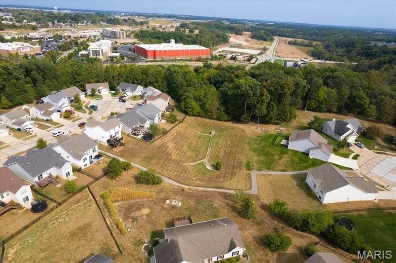 Aerial perspective showcasing a residential development with surrounding green spaces — 521 Cimarron Woods Court, Wentzville, MO 63385