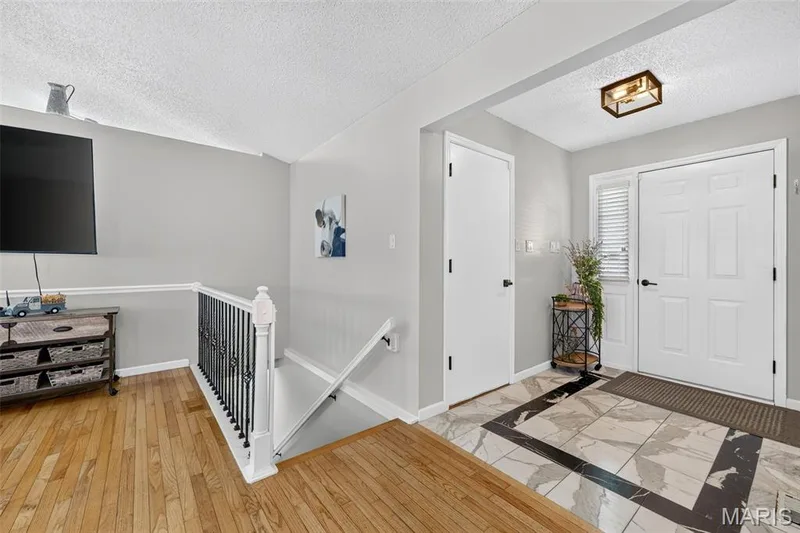 View of the entryway and the stairs leading to the basement. — 2335 Federalist Place, O'Fallon, MO 63368