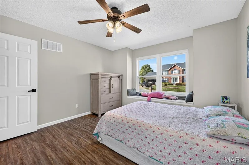 This room features a ceiling fan and a window seat that will be perfect for reading in or decorating! — 2335 Federalist Place, O'Fallon, MO 63368