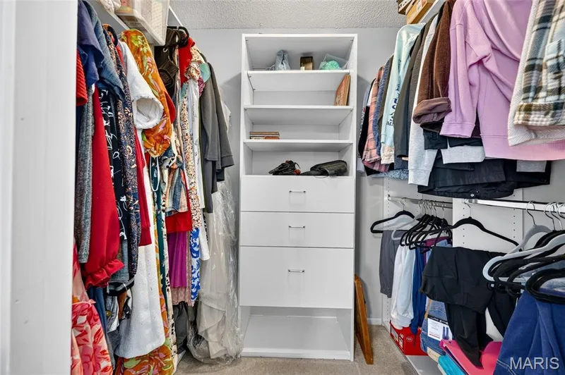 The primary closet features great space and built in shelving and drawers. — 2335 Federalist Place, O'Fallon, MO 63368