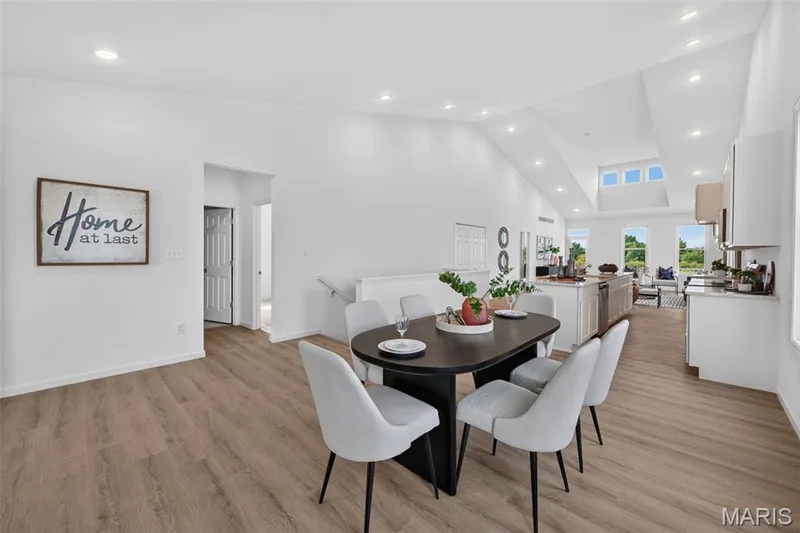 Recessed lighting, LVP flooring, vaulted ceilings, and a skylight feature in this open-concept space — 2974 Memphis Street, St Charles, MO 63301