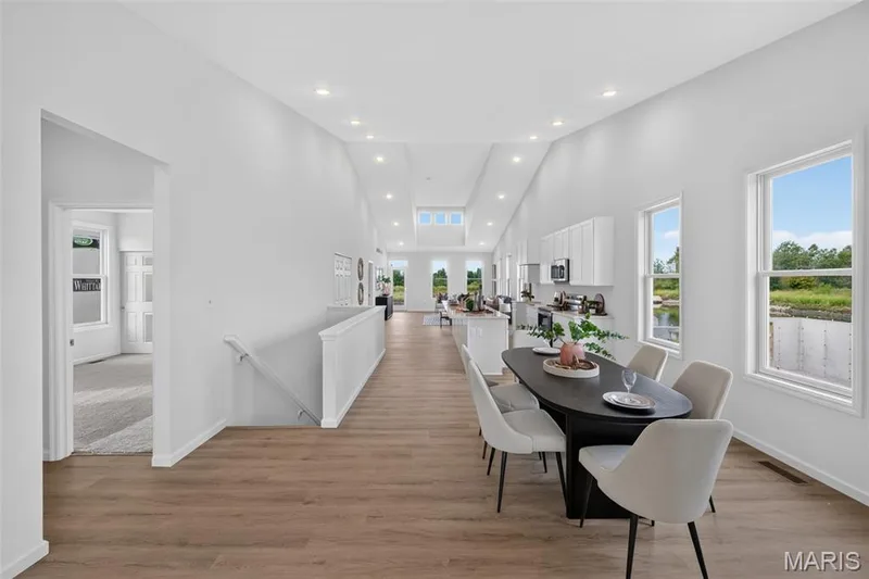 Open-concept living area with LVP flooring, recessed lighting, and multiple windows — 2974 Memphis Street, St Charles, MO 63301