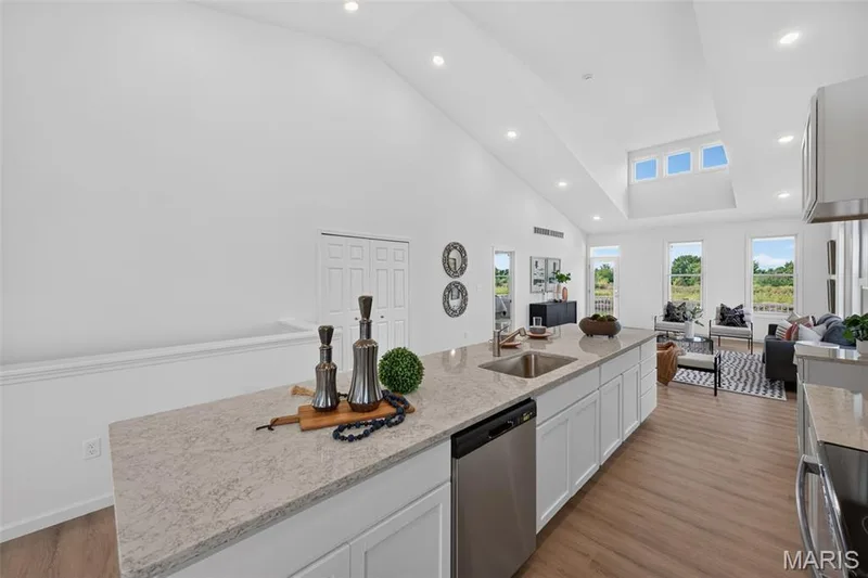 Kitchen island with an undermount sink, stainless steel dishwasher, and quartz countertops! — 2974 Memphis Street, St Charles, MO 63301