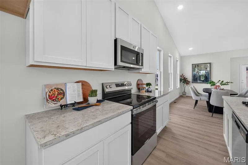 Modern kitchen featuring white shaker-style cabinetry, stainless steel appliances — 2974 Memphis Street, St Charles, MO 63301