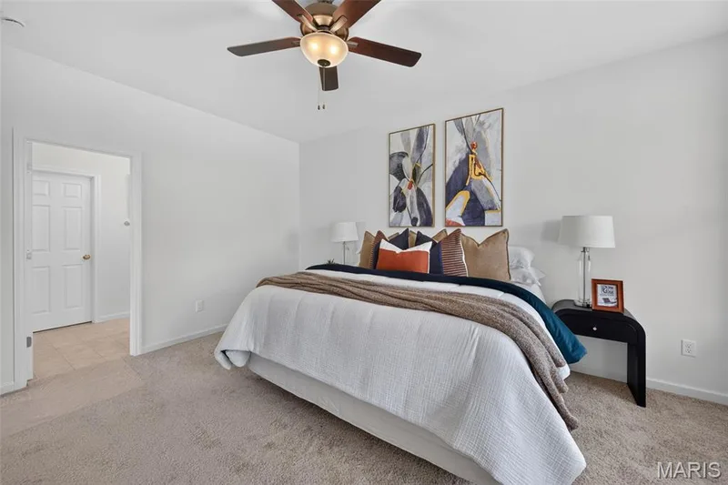 Plush carpeting throughout, complemented by a ceiling fan with integrated lighting — 2974 Memphis Street, St Charles, MO 63301