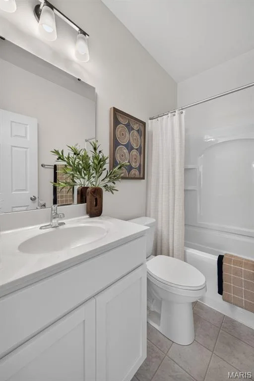 White vanity with integrated sink and chrome faucet, track lighting, neutral flooring, and white toilet — 2974 Memphis Street, St Charles, MO 63301