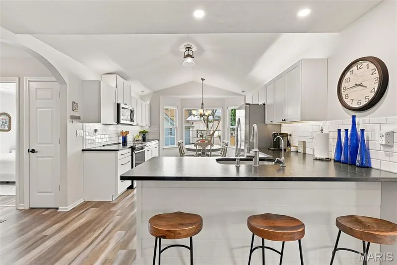 There's a nice Countertop seating that's perfect for Bar Stools. — 14 Quiet Meadow Court, St Peters, MO 63376