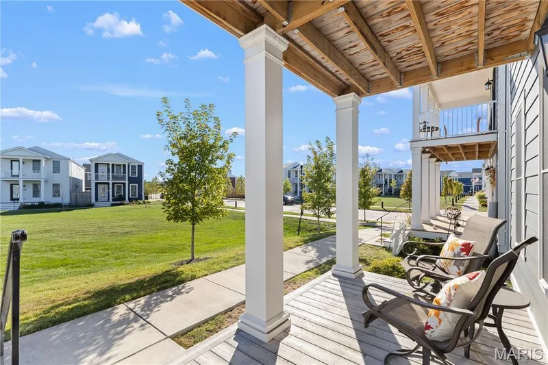 Covered porch with wood-finish flooring and white support columns — 200 Tiber Way, St Charles, MO 63301