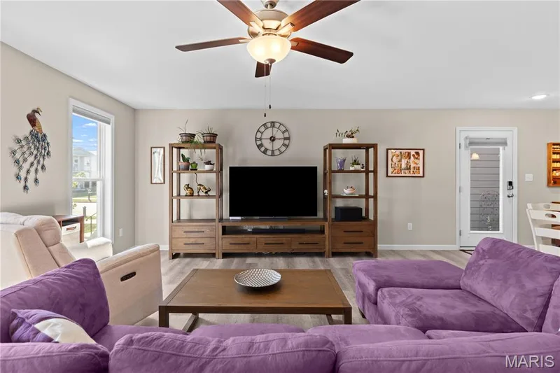 Recessed lighting, ceiling fan with light fixture, luxury vinyl plank flooring, and a side exterior door leading to a private, New Orleans–inspired courtyard — 200 Tiber Way, St Charles, MO 63301