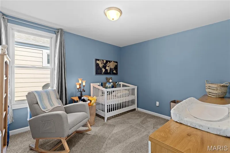 Neutral wall-to-wall carpeting, single overhead light fixture, and a window with white trim — 200 Tiber Way, St Charles, MO 63301