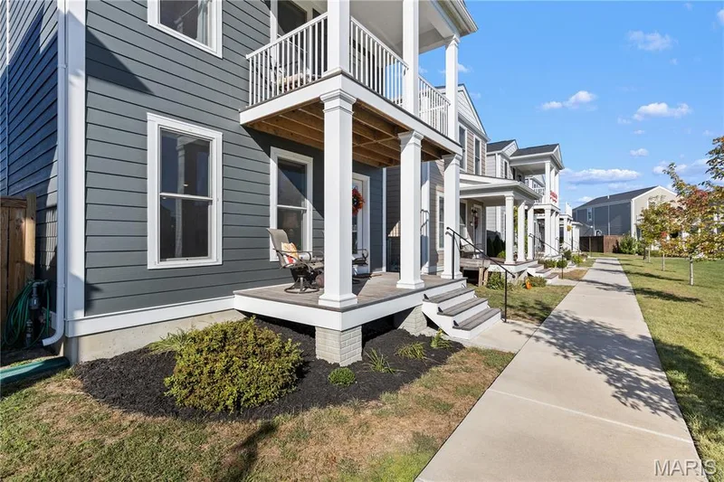 Siding exterior with white trim, covered front porch, and an upper-level balcony — 200 Tiber Way, St Charles, MO 63301