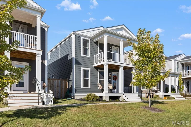 Modern siding exterior with multiple balconies, a covered porch, and white trim accents — 200 Tiber Way, St Charles, MO 63301