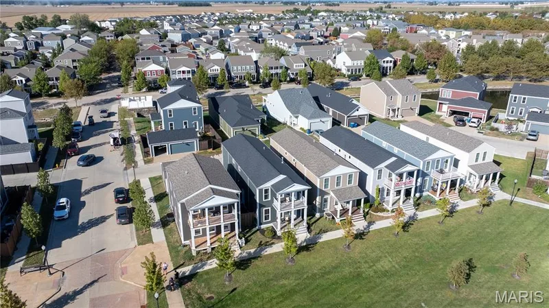 Neighborhood featuring diverse architectural styles, tree-lined streets, and a green space — 200 Tiber Way, St Charles, MO 63301