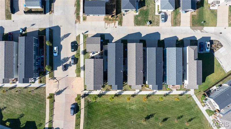 Residential neighborhood featuring varied rooflines, paved streets, and concrete sidewalks — 200 Tiber Way, St Charles, MO 63301