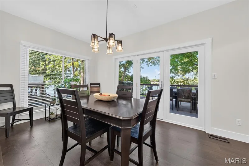 Breakfast room opens to the expansive deck overlooking the lake — 713 High Point Drive, Lake St. Louis, MO 63367