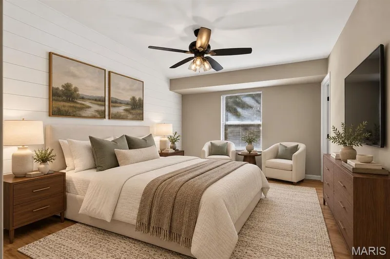 Wood-finish flooring, accent wall with horizontal paneling, ceiling fan with light fixture, and window with natural light — 341 Westbrook Drive, O'Fallon, MO 63366