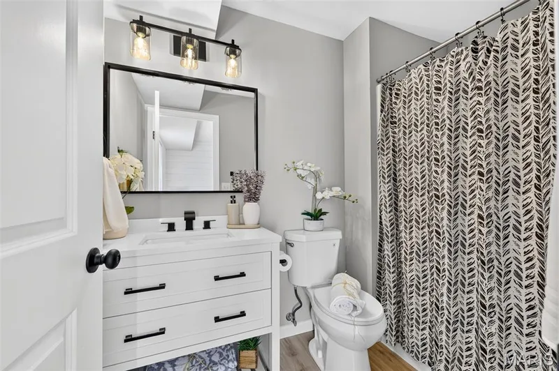 White vanity with black hardware, rectangular sink, and matte black faucet — 341 Westbrook Drive, O'Fallon, MO 63366